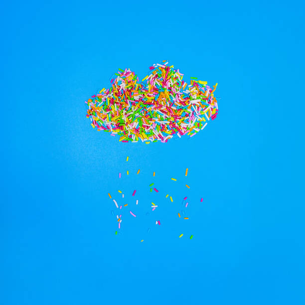 istock Sprinkles in shape of rainy cloud and rain drops, flat lay, blue background, square image. Baking or birthday concept 869081076