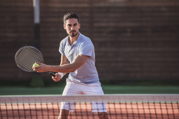istock Man playing tennis 869081560