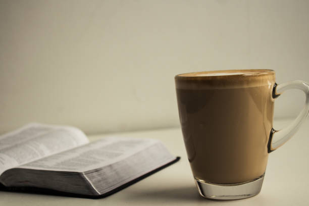 istock open bible and a cup of cappuccino 869081676