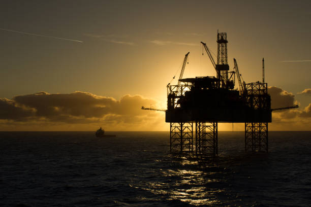 istock Oil rig in sunrise light 869084194
