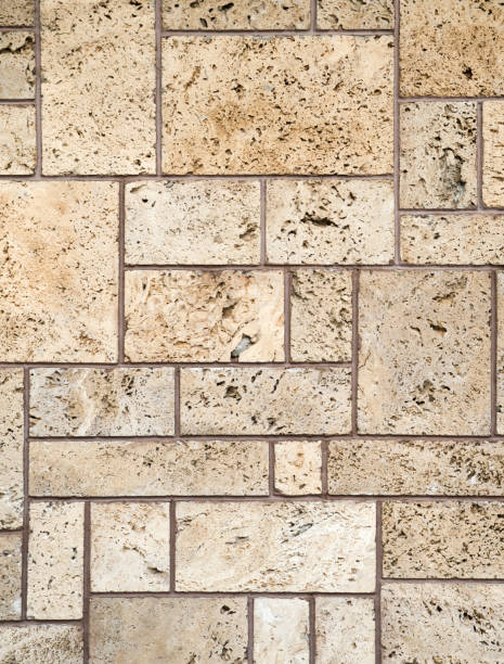 istock New ecru travertine wall closeup  in sunny day 869086186