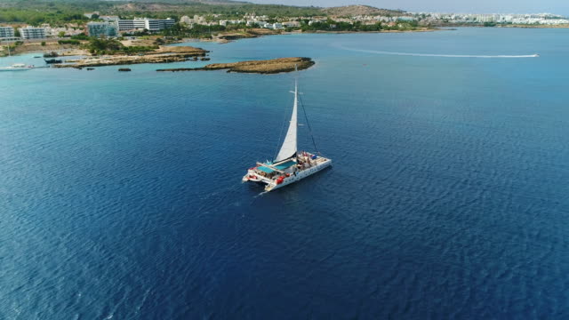 Sailling catamaran in the Mediterranean sea, Ayia Napa, Cyprus.  Aerial drone shot.