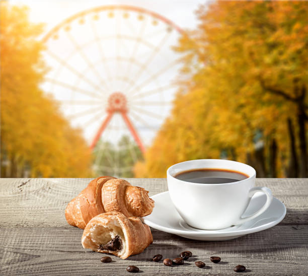 istock Cup of coffee with croissants 869091754