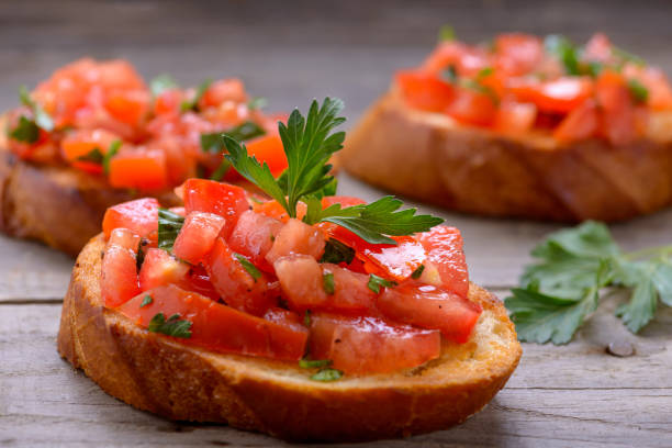 istock Tasty bruschetta with tomatoes and herbs 869095144