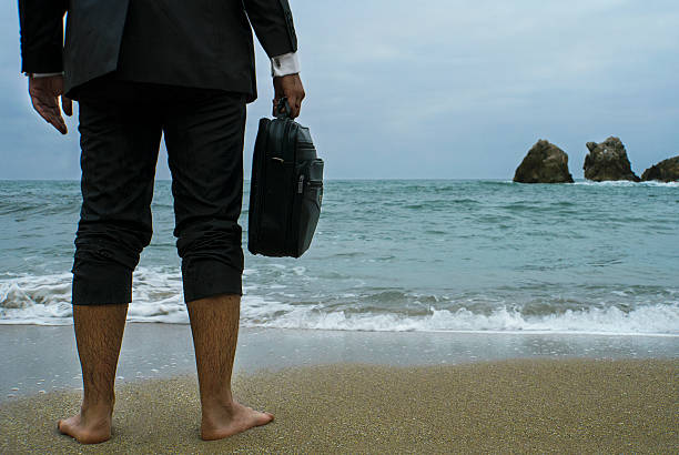 istock Waiting Businessman on the Beach 869098480