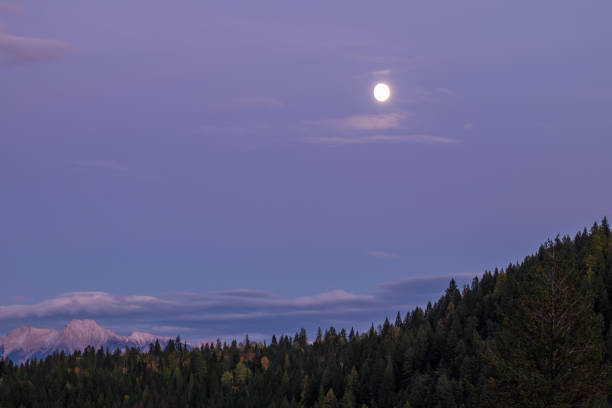 Close-up of a moonrise over the Rocky Mountains in British Columbia, Canada stock photo