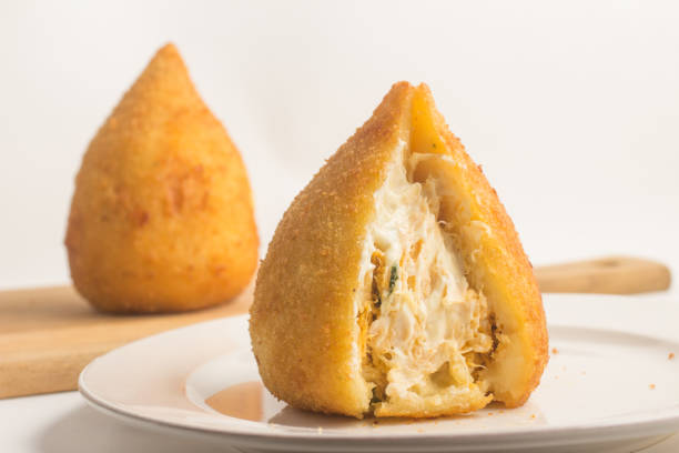 Brazilian Chicken Coxinha Brazilian Chicken Coxinha over a white background coxinha stock pictures, royalty-free photos & images