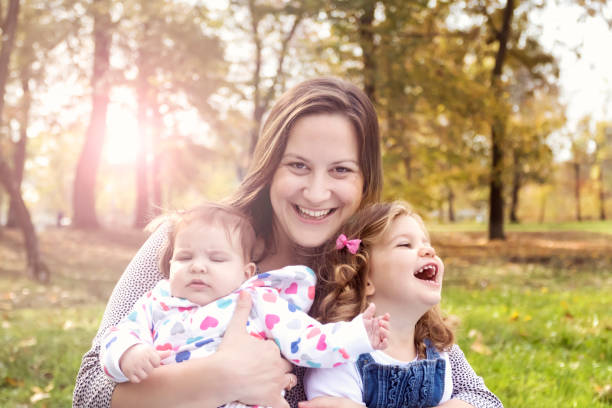 Mom and two children smiling
