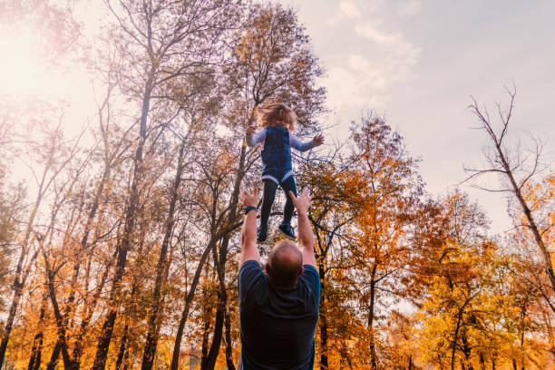 istock Playing with dad. Father having fun throws up in the air child 869125094