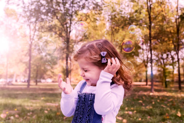 istock Happy child playing in a spring garden 869125376