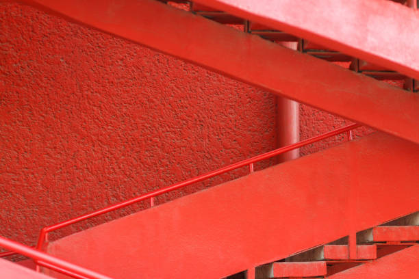 istock Red staircase near the red wall. 869128022