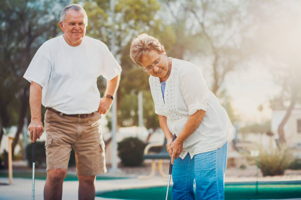 istock retired married elderly couple playing mini golf together 869128280