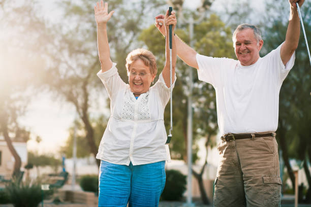 istock senior couple celebrating playing miniature golf 869128288