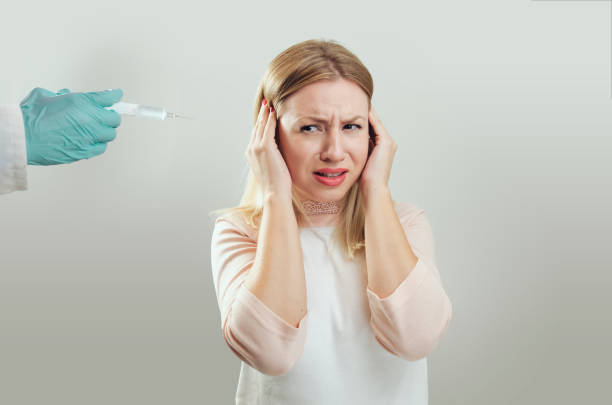 istock Young woman afraid of needles 869128884
