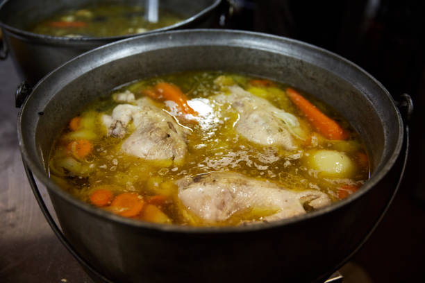 istock Soup with vegetables is cooked on the stove in the kitchen 869132002