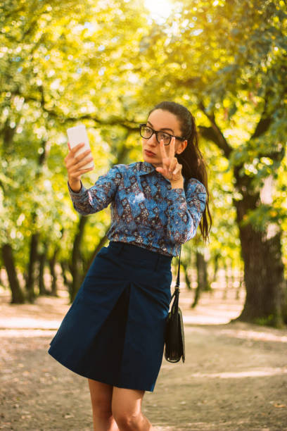 istock Hipster businesswoman using phone in the nature 869135540