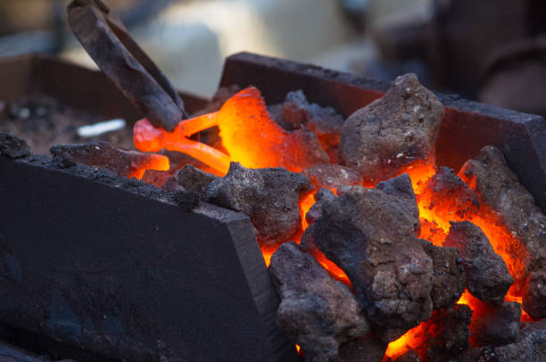 istock blacksmith furnace with burning coals, tools, and glowing hot metal workpieces 869136012