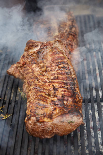 istock Steaks fry on a grid with seasonings and herbs on them 869138874