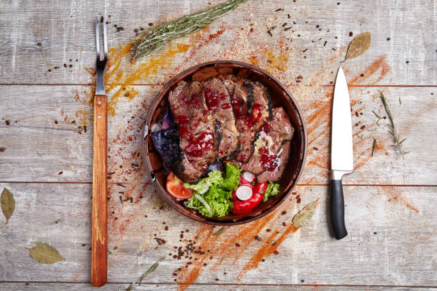 istock Authentic wooden plate with steak and vegetables and sauce 869141832