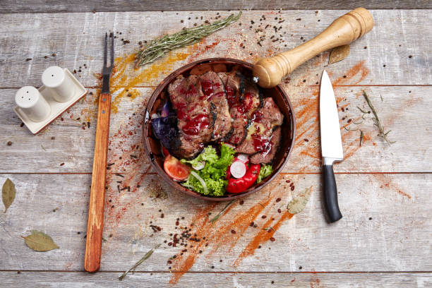 istock Authentic wooden plate with steak and vegetables and sauce 869142010