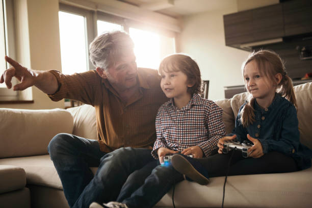 istock Grandchildren having fun with grandfather 869144606