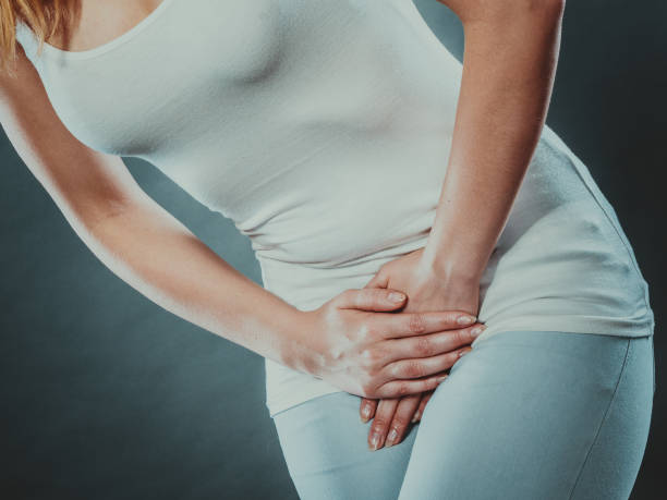 istock woman with hands holding her crotch 869148310
