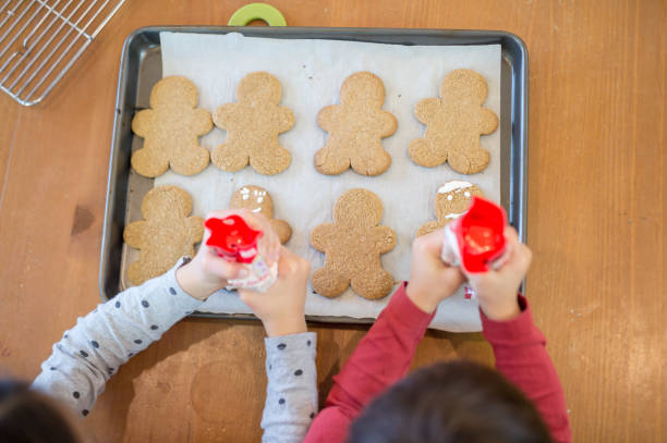 istock Two boys cheerfully help their mom bake Christmas cookies 869152180
