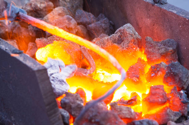 istock blacksmith furnace with burning coals, tools, and glowing hot metal workpieces 869158756