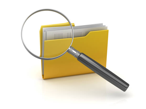 istock Magnifying glass over the yellow folders 869159772
