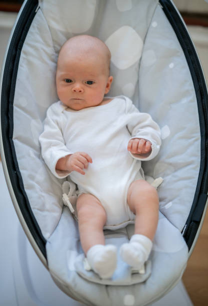istock Beautiful baby lying on a bouncer 869160596