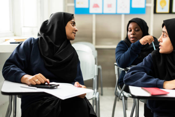 diverse muslim girls studying in classroom