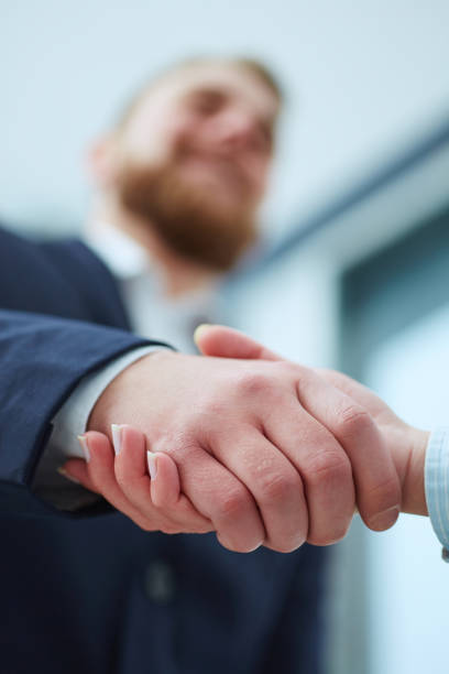 istock Male and female handshake in office. 
Focus on hands. 869174690
