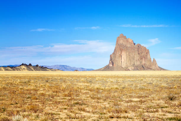 istock Shiprock, NM Desert Landscape with Famous Rock, Blue Sky 869178254