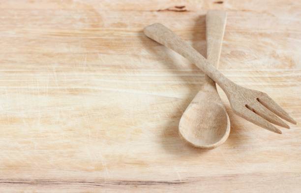 istock Wooden spoon and fork on wood background 869185158