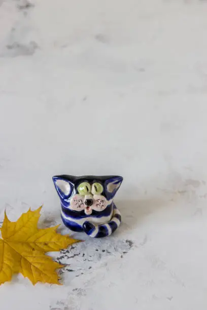 Photo of Ceramic handmade cat on a white background