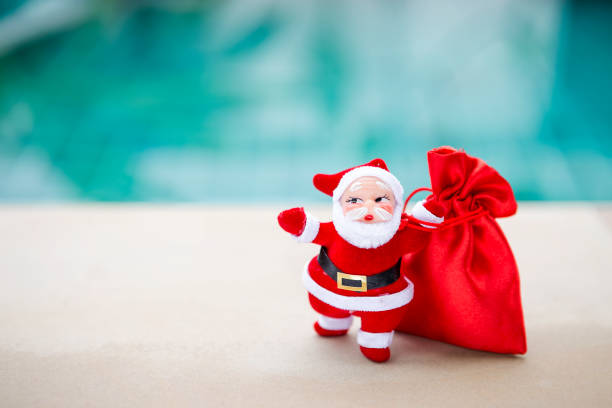 Santa Clause with red gift bag over blurred blue background, Christmas concept