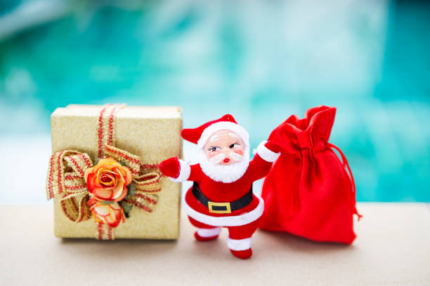 Cheerful Santa Claus packing Christmas presents