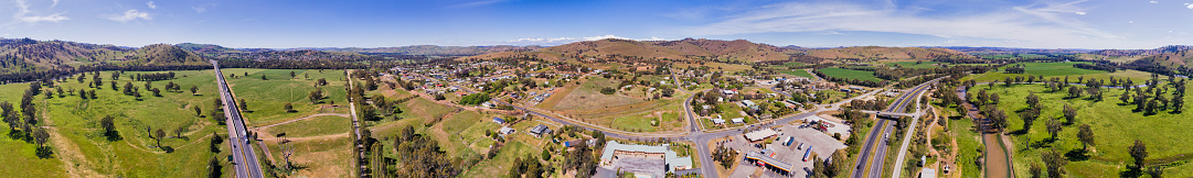 Gundagai historic town on Sydney - Melbourne high speed Hume highway famous for Dog on the Tuckerbox. Aerial wide country side panorama with town houses and streets along the motorway.