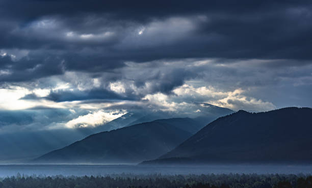 istock Dramatic sunrise in the mountains with thick evergreen forest in foreground, Altai Mountains, Kazakhstan 869199660