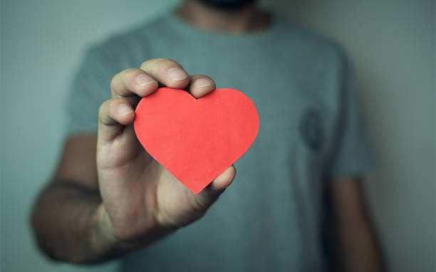 istock Man holding red heart. Love concept. 869206602
