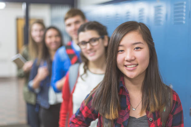 istock Small group of high school students pose in the hallway 869210318
