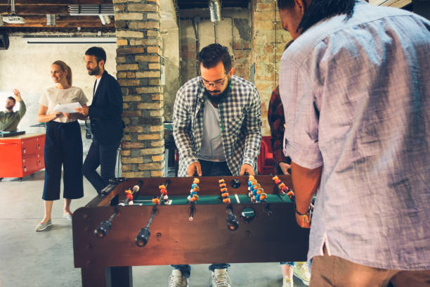 istock Coworkers playing foosball 869211178