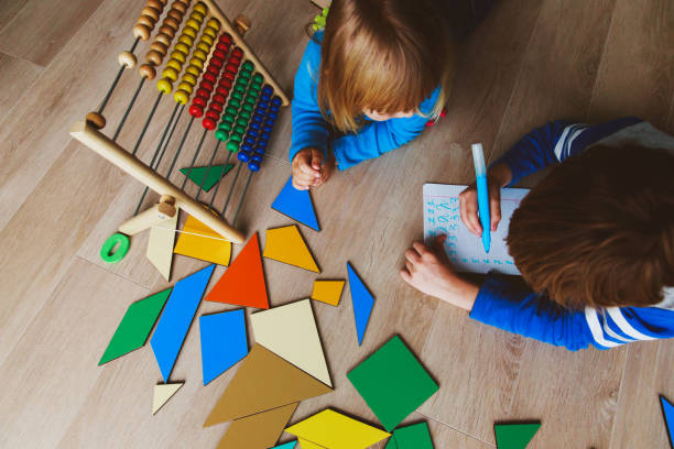 istock little boy and girl learn to write and calculate numbers 869218398