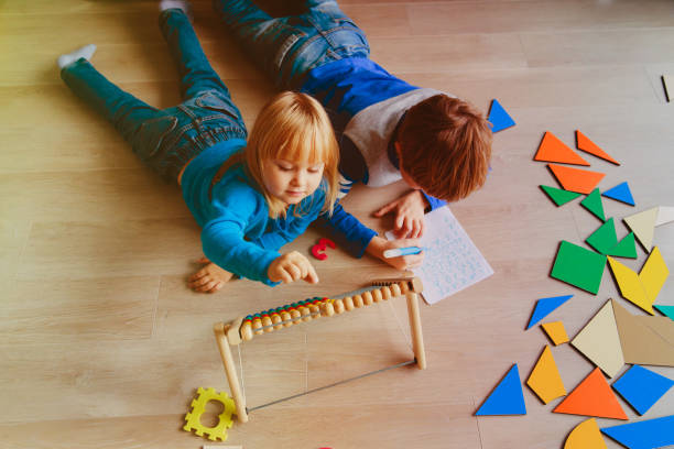 istock little boy and girl learn to write and calculate numbers 869219216