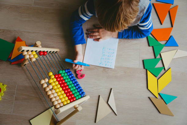 little boy learn to write and calculate numbers stock photo