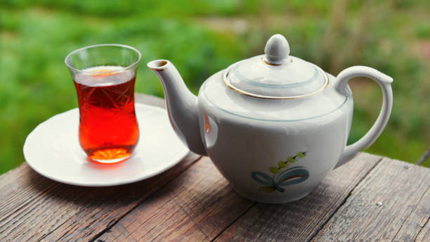 istock Fragrant black tea on wooden table in garden 869226188