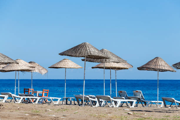 istock Sunbeds and umbrella on the beach, close up. Turkey 869226236
