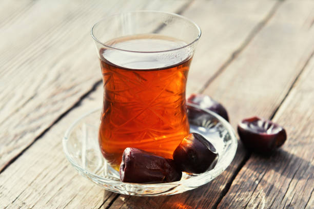 Fragrant black tea on wooden table in garden