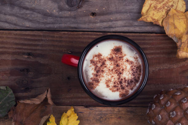 istock Coffee, dry leaves abd cone on wooden background 869229596