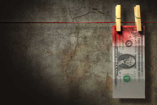 Mony laundry 3D illustration. A blood stained dollar bill hung up to dry. Money laundry concept. bloody money stock pictures, royalty-free photos & images